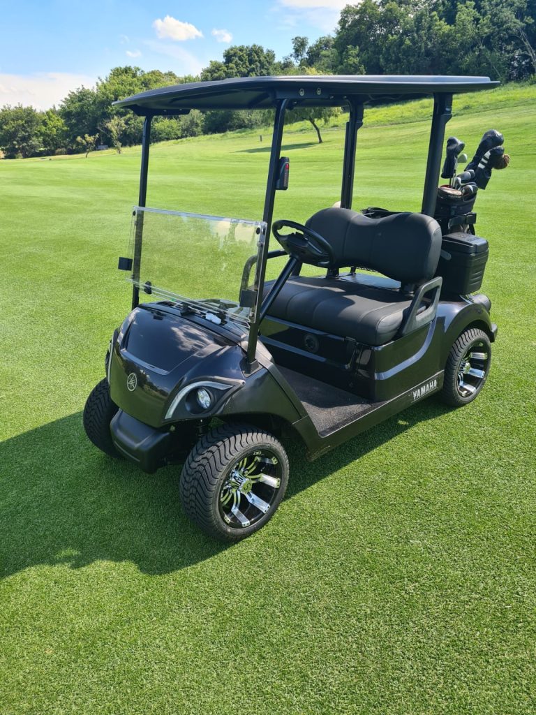 image of black golf cart with custom mag wheels.